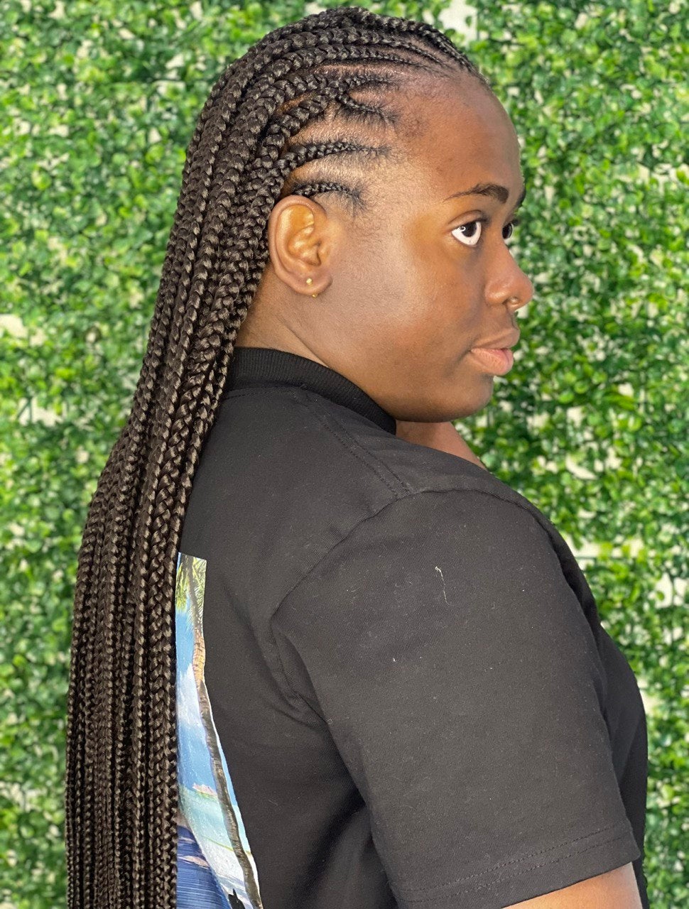Long feed-in cornrows styled to the back